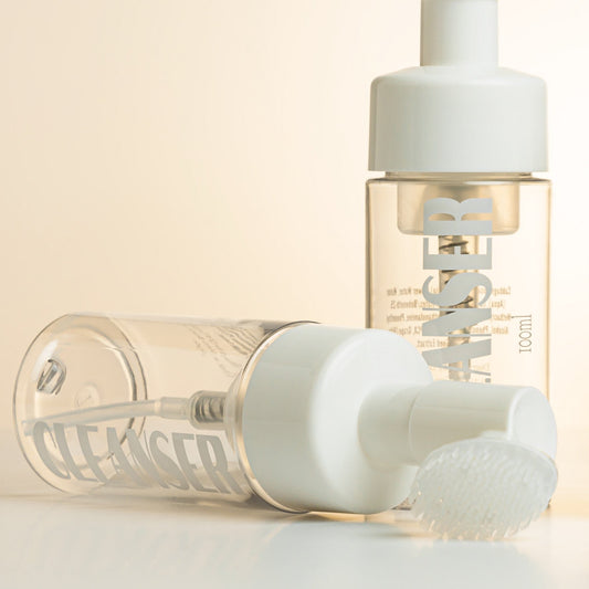 GT Lash Co 2-in-1 foaming lash cleanser bottle with built-in brush — professional eyelash extension shampoo for aftercare and eye hygiene